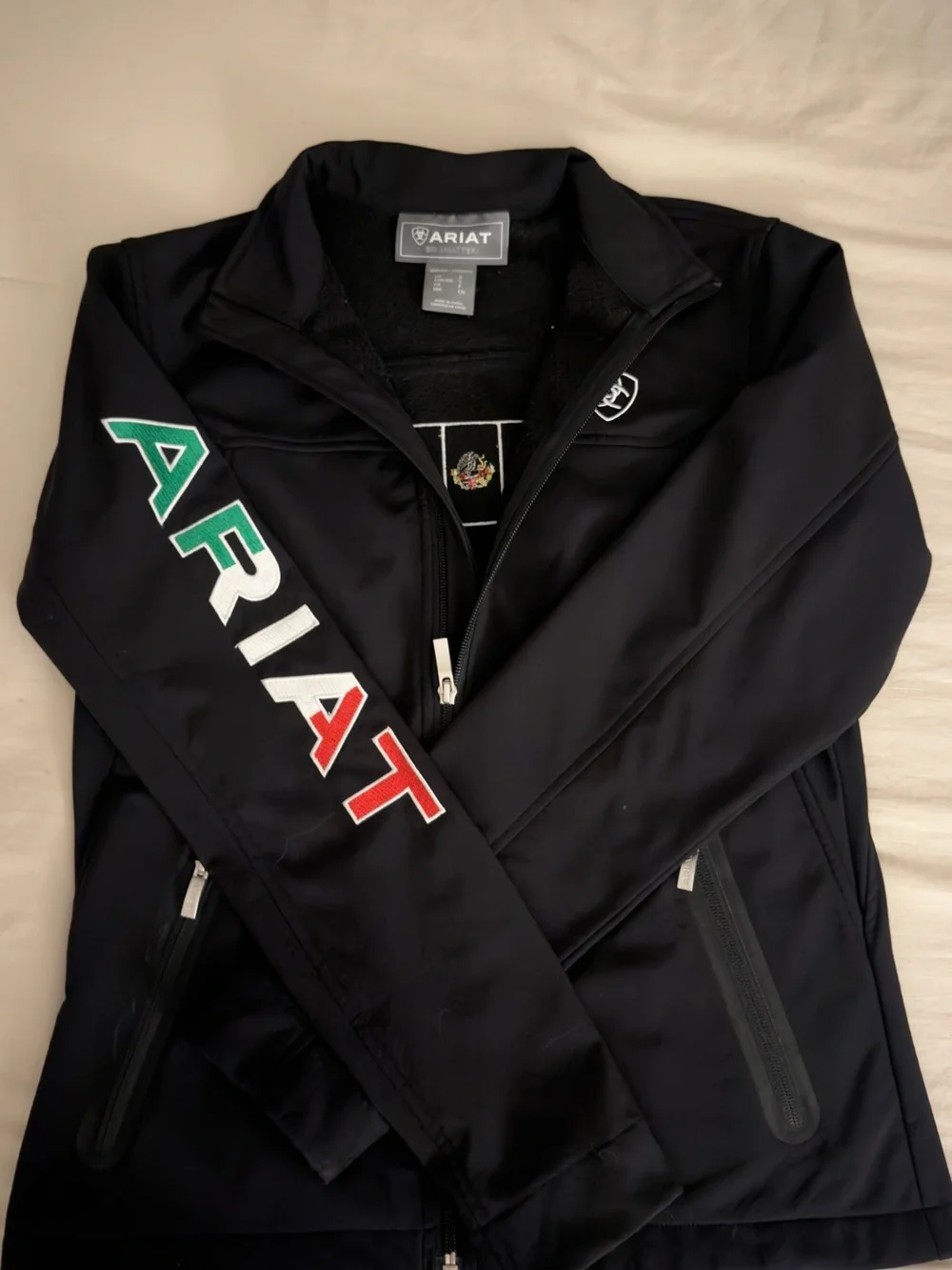 Women’s Ariat Black Softshell Jacket with Green, White & Red Sleeve Logo